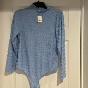 Free People light blue body suit with tags.
